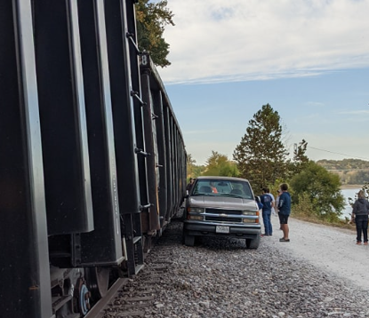 Train strikes pickups parked along track by Tower Rock onlookers