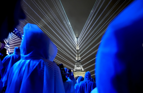 Paris Olympics open with rain-soaked river ceremony