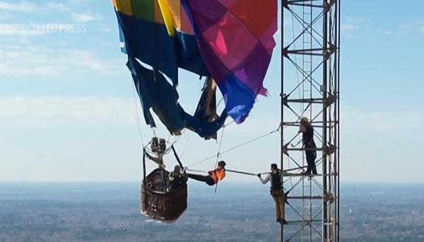 Two rescued after hot air balloon snags on communications tower 900 feet off ground